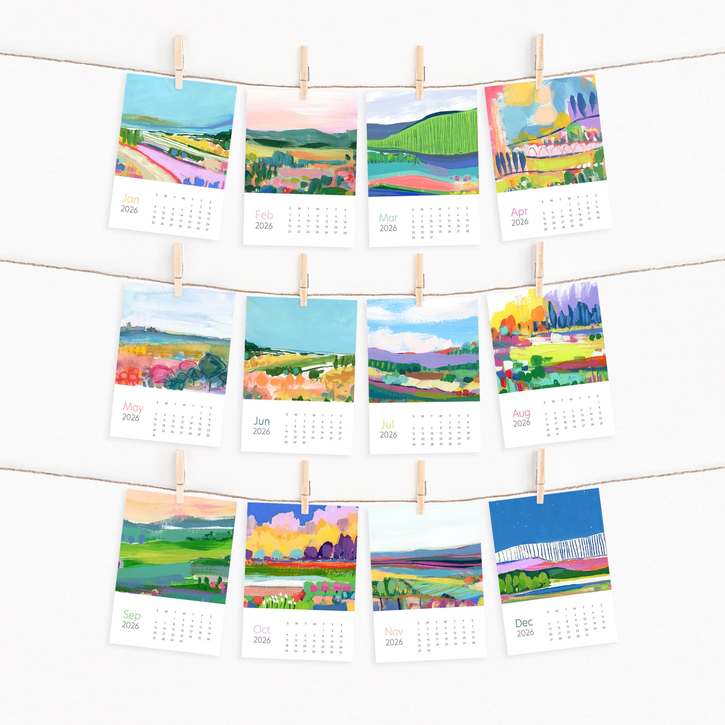 Desktop calendar by Melissa Doty with color landscape images hanging on a line with clothespins.