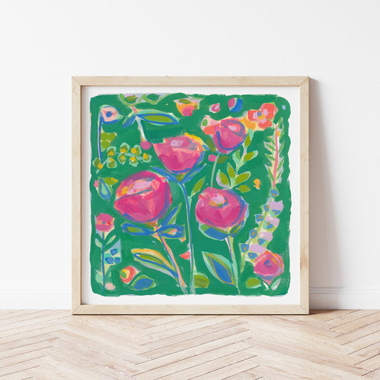 Framed colorful pink and green floral artwork on a white wall