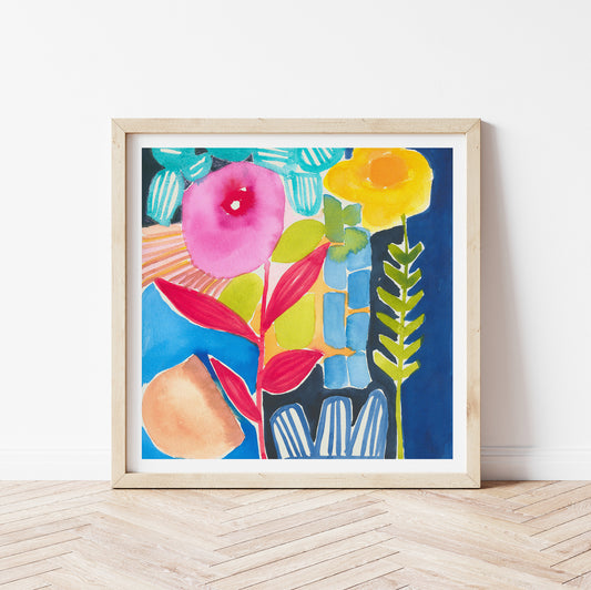 Framed colorful abstract floral art print on a white wall