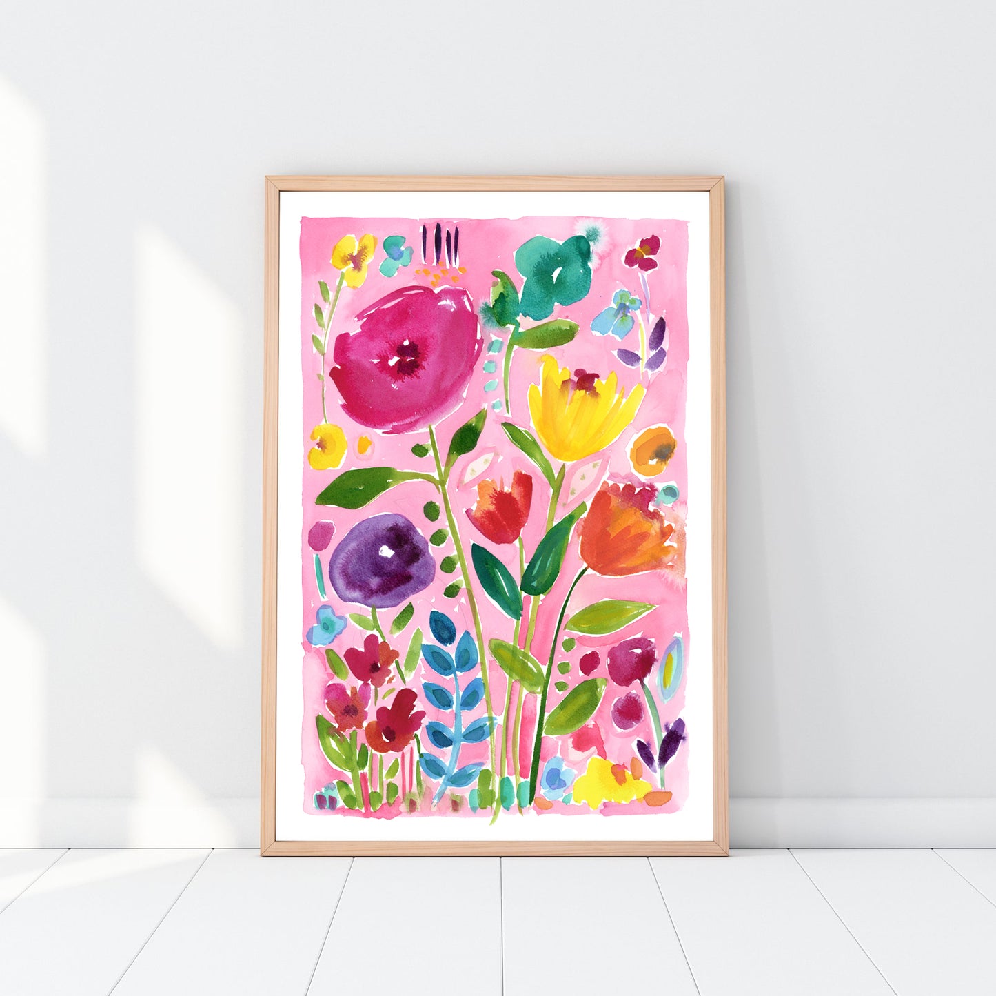 Color pink abstract floral art print in a wood frame against a white wall